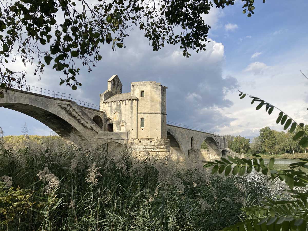 Stone bridge and gatehouse over the river in Avignon, France.