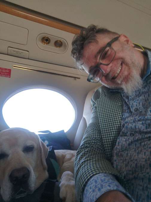 60ish year old man and sleepy yellow English lab in selfie