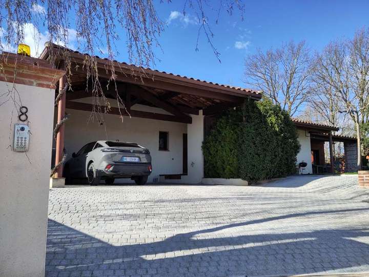 View of drive and carport and car