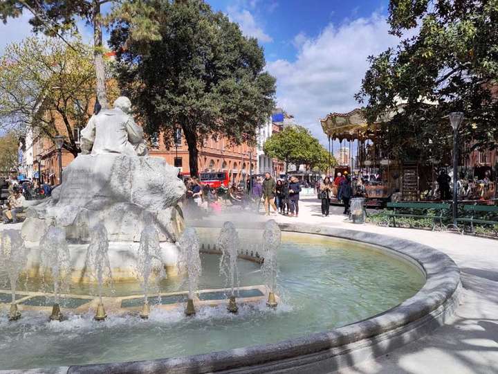 fountain in foreground carousel in background