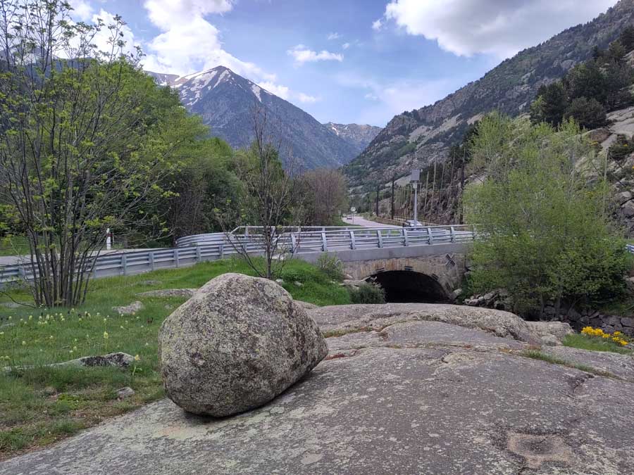 View of pyrenees with boulder and bridge in foreground
