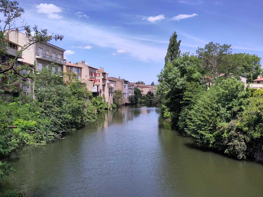 View from bridge of river through Castres